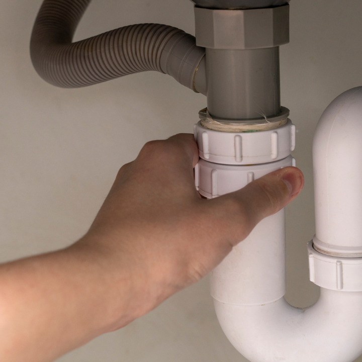 inspector checking plumbing during a full home inspection in fort lauderdale florida