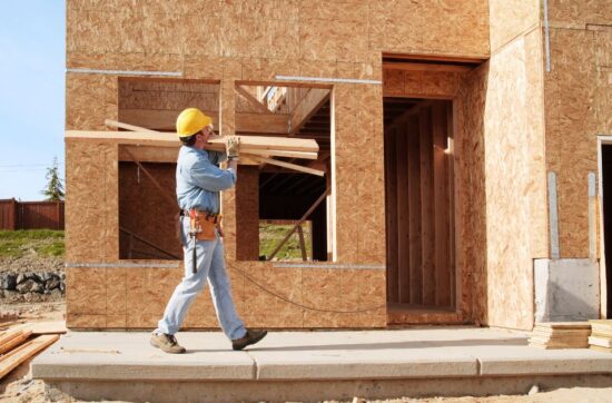 contractor carrying wood for new home before home inspection